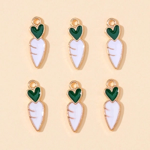 Detail view of carrot enamel charms for jewelry making with green tops and white bodies
