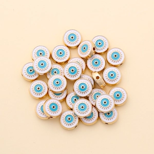 Detail of 10mm evil eye beads with golden gears for DIY jewelry making and bracelets