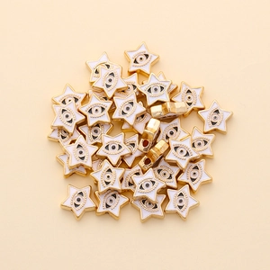 Detail of star-shaped 10mm evil eye beads with golden alloy frame for DIY jewelry making