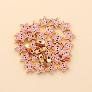 Macro shot of 10mm pink star evil eye beads with gold plating for DIY jewelry