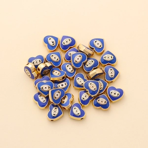 Macro shot of 10mm golden heart-shaped evil eye beads for DIY jewelry making