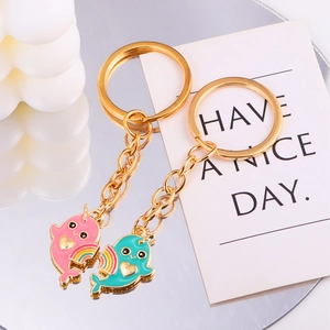 Detail of whale keychain set with pink and blue cartoon pendants for couples