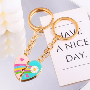 Detail of puzzle heart keychains with rainbow stripes and daisy charms on mirror