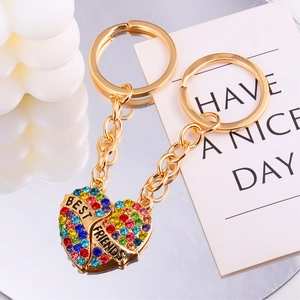 Detailed macro view of heart-shaped gold keychain with multi-color rhinestones and BEST FRIENDS text