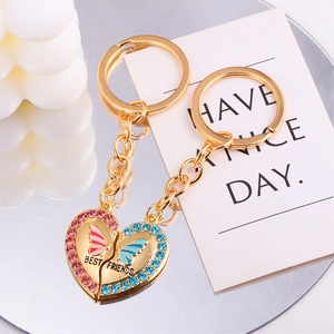 Detail of heart puzzle keychains with pink and blue crystals and Best Friends engraving