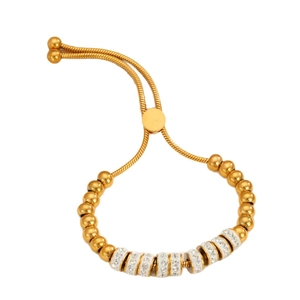 Verstelbare gouden kralenarmband met met kristal bezette strikbedeltjes en schuifsluiting