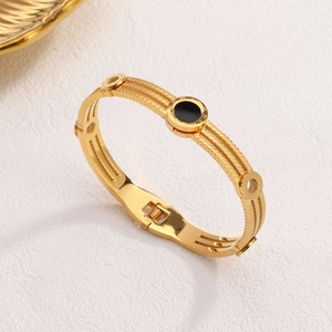 Rose gold Roman numeral bangle featuring a black center and twisted triple-strand band