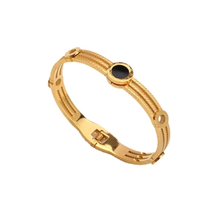 Three-layer gold titanium steel bangle featuring black circular inlay and Roman numerals