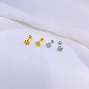 Detailed close-up of 18K gold and silver Fu character screw back stud earrings