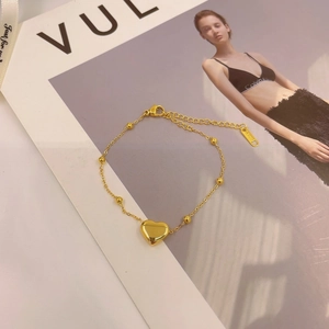 Elegant gold titanium steel heart charm bracelet with polished beads and lobster clasp