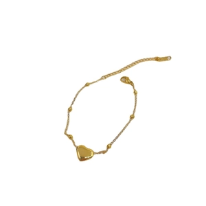 Elegant gold titanium steel heart bracelet featuring delicate beads and adjustable lobster clasp