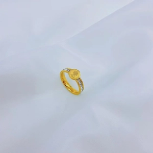 Golden Elizabeth II portrait coin ring with rows of white zircon on the band side