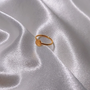 Minimalist 18K gold plated titanium steel ring with Chinese Fu character on white silk