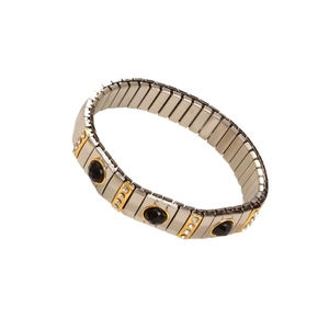 Elastic stainless steel bracelet with 18K gold trim and black stones on white background