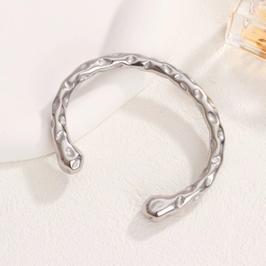 Minimalist silver hammered stainless steel open bangle with a polished textured finish