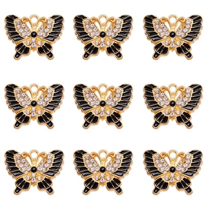 Macro detail of nine butterfly charms with rhinestones and black enamel for DIY jewelry