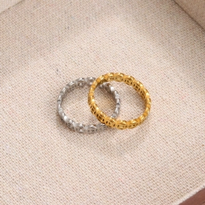 Titanium steel ring set in gold and silver with hollow Chinese coin patterns