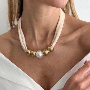 Detail of beaded leopard print scarf necklace with gold metal balls and large white pearl