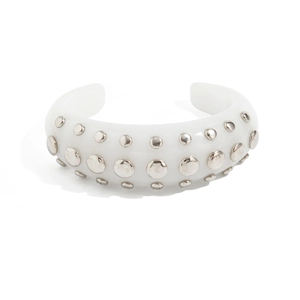 Detailed view of white resin open cuff bracelet with silver metallic rivet studs