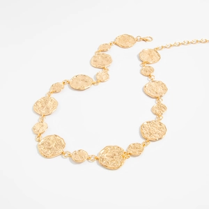 Close-up of golden hammered metal discs with lobster clasp and adjustable body chain