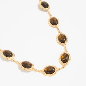 Vintage gold body chain belt featuring oval brown resin stones and wave textured metal frames