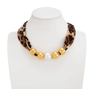 Detail of leopard print silk neckband with gold beads and a white imitation pearl