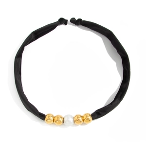 Minimalist black silk cord necklace with golden metallic beads and a white pearl accent