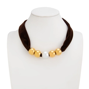 Detail of vintage velvet leopard scarf necklace with gold beads and a central faux pearl