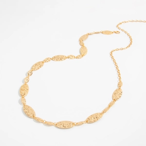 Detailed view of hammered gold oval metal disks and adjustable chain with lobster clasp