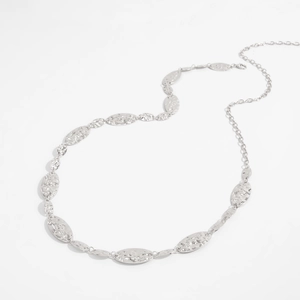 Close-up of silver-tone oval chain belt featuring hammered metal texture and lobster clasp