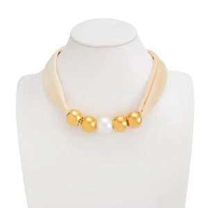 Detail view of velvet fabric choker with golden spheres and a central white pearl ornament