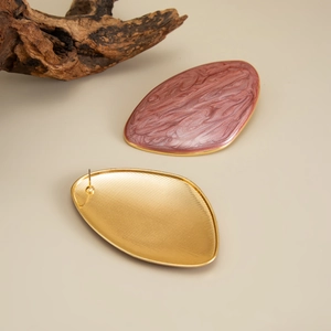 Detail of reddish-brown marble enamel earrings with gold metal textured back
