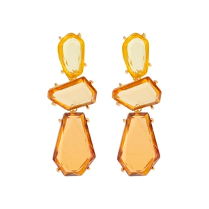 Detail of geometric resin drop earrings featuring warm amber gradient stones and gold claws