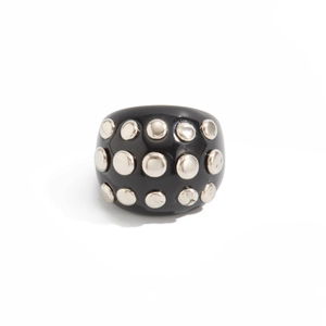 Macro detail of wide black resin ring featuring double rows of silver metal studs
