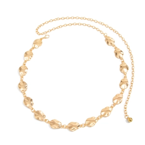 Detailed view of golden metal waist chain with textured oval discs and lobster clasp