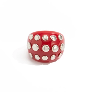 Macro view of chunky red resin ring featuring three rows of polished silver metal studs