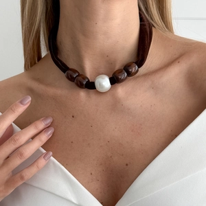 Detail of baroque pearl and brown wooden beads on a soft velvet cord necklace