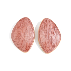 Detailed top view of geometric resin stud earrings with pink marble texture and gold edges