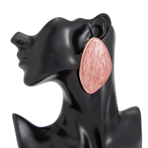Macro detail of large pink marble enamel stud earring with gold-plated metal border