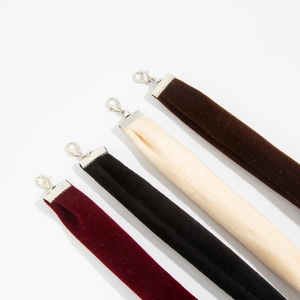 Detail view of four velvet choker necklaces in burgundy black cream and brown colors