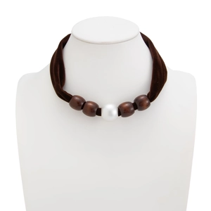 Close-up of velvet choker with leopard print silk scarf nodes and faux pearls