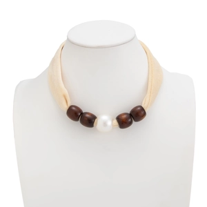 Detailed close-up of a fabric choker with large white pearl and brown wooden beads