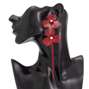 Detail of red flower tassel earrings with crystals and fringe on model head