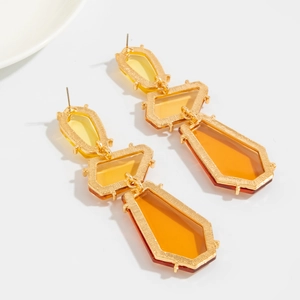 Detailed view of vintage gold geometric earrings with yellow and orange resin stones
