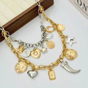 Chunky mixed-metal layered necklace featuring star, heart, and coin pendants on chains