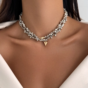 Close-up of dual-tone layered choker with silver irregular beads and gold heart pendant