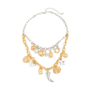 Flat lay of retro layered necklaces with star, heart, and coin charms on white background
