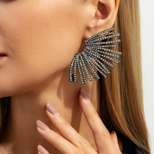 Macro detail of statement fan earrings featuring pavé rhinestones in gunmetal finish