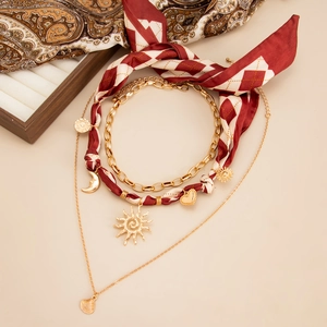 Mehrlagige goldene Halskette im Boho-Stil mit Seestern-Anhängern und rot gemustertem Seidentuch
