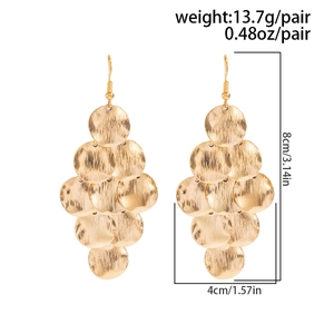 Detail view of layered gold geometric disc drop earrings with size and weight specs